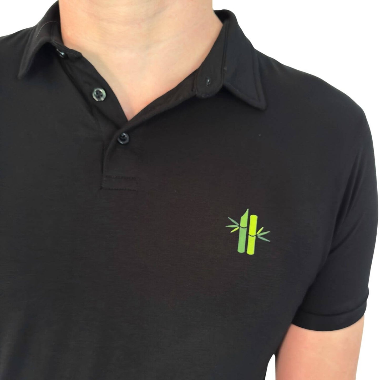 Close up of of bamboo embroidery and collar on model wearing an Athletic Bamboo Polo in black - Robumi Lifestyle