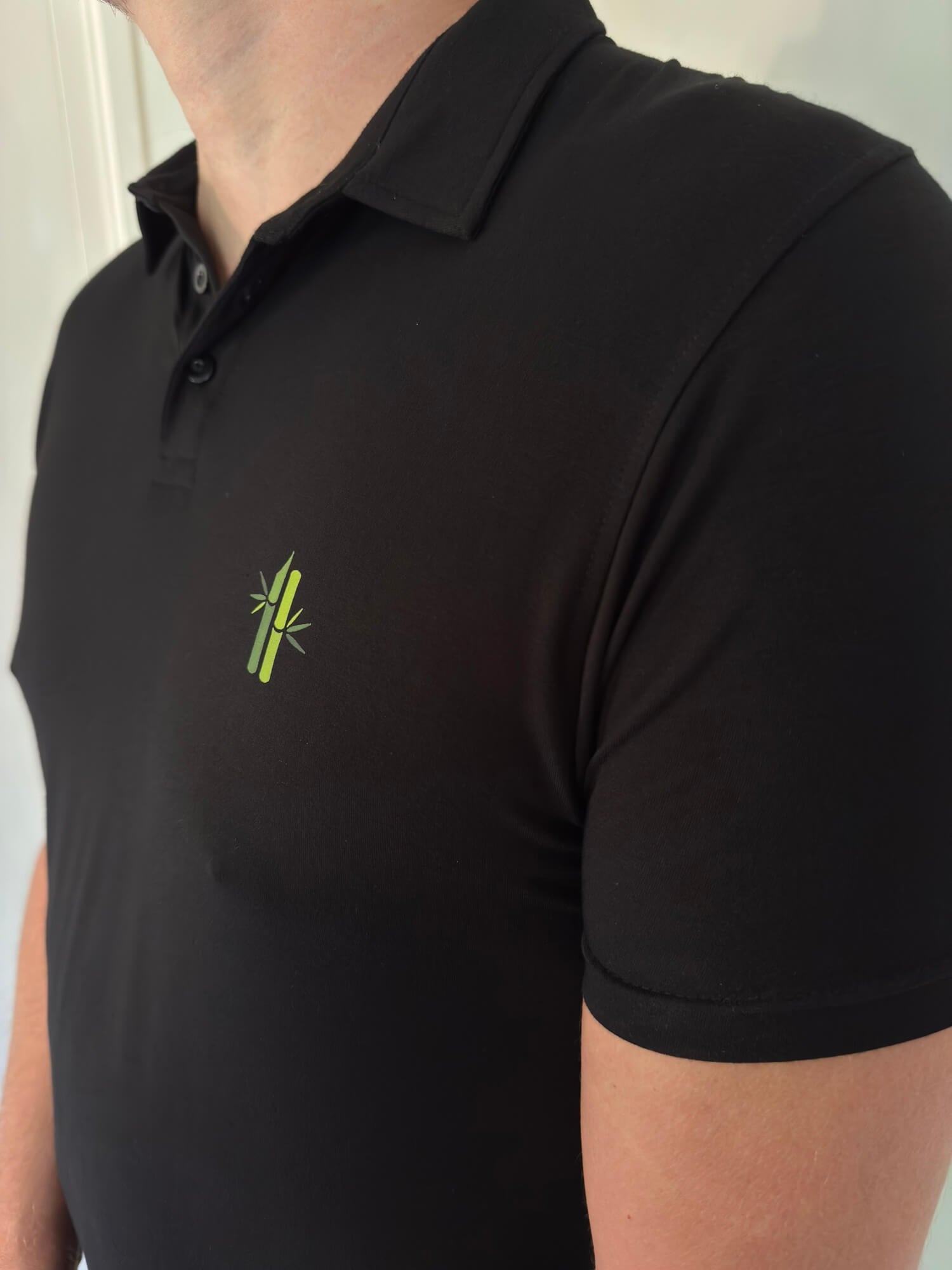 Side view of model wearing an Athletic Bamboo Polo in black - Robumi Lifestyle