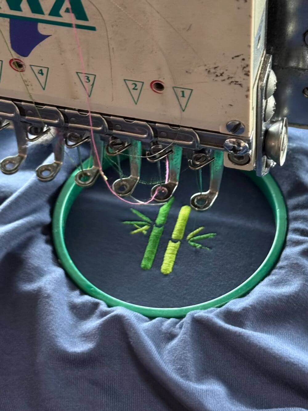 Embroided bamboo logo on fabric during embroidery